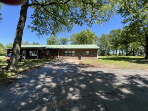 Enjoy the matinance free exterior of this brick home, including the metal roof, gutters and downspouts. Nice split floor plan with oversized primary bedroom with walk-in closet. Nice detatched shop / garage all sitting on a nice shaded one acre lot. Seller is giving a $4000.00 flooring allowance for the 2 bedrooms in need of flooring.
