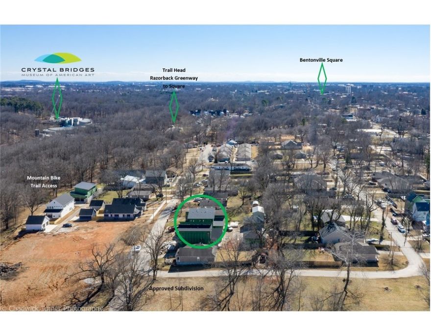 Look out your front door and see the mountain bike trails from this modern new construction home in downtown Bentonville. Peek-A-Boo, Boo Boo & Patti-Cake trail are located right across the street connecting you into Slaughter-Pen and over 80 miles of mountain bike trail or if you are looking to get on the greenway, the trail head on NE A ST is a short walk and you can access the Crystal Bridges Overlook. The Briartown area is exploding with new development. This home features modern details from its sloped room design to its cantilevered island and spa like bath. The kitchen is amazing featuring GE Cafe Series appliance including a 46" industrial range along with a 72" built in fridge and a huge pantry with wine storage. The open main living area features 12' ceilings. The owners suite is also on the main level and features 10' ceilings and one of the most amazing showers you have ever seen. Upstairs are 3 large bdrms, a family room, laundry area and an upper deck. The yard is fence plus a 3 car garage.