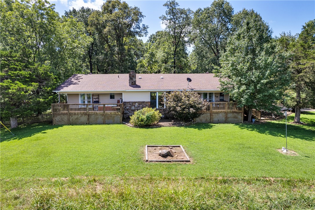 Nestled in a private, picturesque setting just 1 mile from the lake, this 3-bedroom, 2-bath home offers a tranquil retreat for nature lovers. Surrounded by mature trees and a mix of wooded and pastureland, it sits on a scenic hill with peaceful valley views, two serene creeks, and a beautiful winter view of Beaver Lake. Inside, youāll find wood floors in the master and family rooms, a large den, and a striking floor-to-ceiling natural rock fireplace with gas logs (convertible to wood-burning). The home features a Bosch dishwasher, pantry, and generous kitchen island for both cooking and gathering. Equipped with an alarm system and accessed via a legal easement off JD Stahl Rd, this home is both secure and secluded. Enjoy the outdoors with two spacious decksāone featuring an oversized Hot Springs hot tub. The property also includes a versatile pole barn, shed, and two-car carport, offering plenty of storage and workspace. Peaceful, well-kept home surrounded by nature and privacy