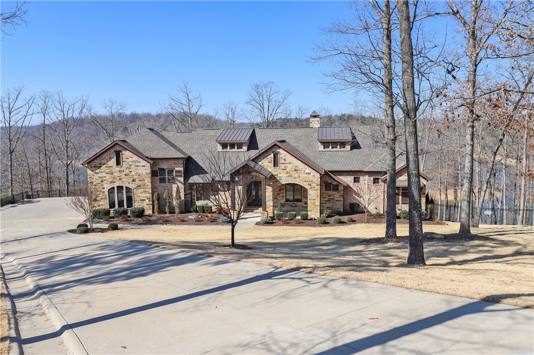 CUSTOM BUILT LAKEFRONT ESTATE OFFERING GORGEOUS LAKE VIEWS & PRIVATE 2 SLIP BOAT DOCK! Beautiful 2.60 acre setting w/easy access to lake & dock! Spacious screened deck & huge lower patio w/hot tub & fire pit! The stunning interior offers top of the line amenities throughout including wood flooring, knotty alder cabinetry, granite, custom wall finishes, high ceilings w/ rustic beams and large picture windows offering fabulous views! Walk-out basement w/bonus, bed, full bath! Don’t miss this PRISTINE custom estate!!
