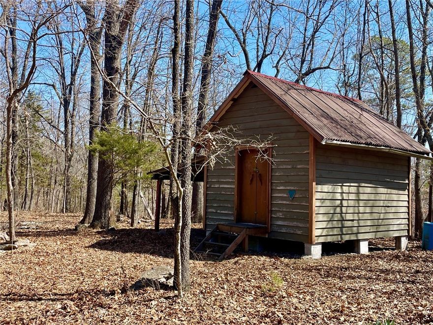 Discover your slice of paradise with 16+ unrestricted acres on a secluded ridgetop in the quiet Hogscald Hollow area of Beaver Lake near Eureka Springs. Rustic 12 x 16 sleeping cabin with an attached pole shed for additional covered storage. Numerous building sites with views to the east or west and with southern exposures. Deer, bear, turkey and other small wildlife and a variety of birds. Electric company easement on one end of the property provides easy access to electric. Well and septic needed. Small pond filled by rain water. Private road dead ends on the property and is maintained by the property owner. Only 1.25 miles to Beaver Lake public access and 10 miles to downtown Eureka Springs.
.
