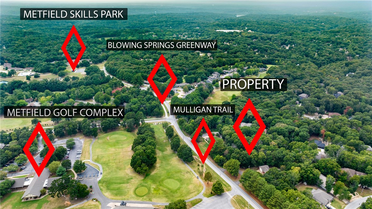Here's a lot with SEWER access on a cul-de-sac in a coveted part of Bella Vista. Sitting just across the street from the Metfield golf course and clubhouse, there is also Mulligan Trail across the street and the paved Blowing Springs Greenway and Rago mountain bike trail just around the corner. There is only a mild slope to the lot. Some of the photos in this listing include drone photos with boundary lines to give some idea of the shape and size of the lot. These lines are approximate and are not to be construed as accurate as what a survey would show. Be sure to click on the virtual tour link to get a bird's eye view in video of the lot and its surroundings.