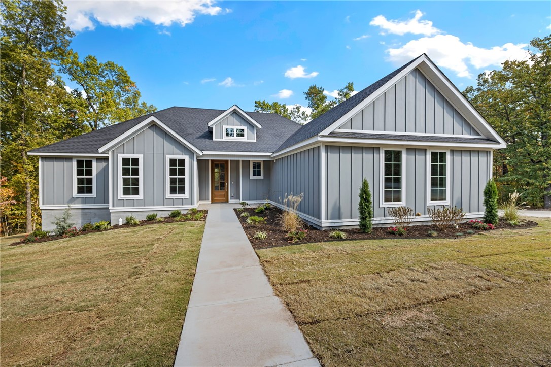 You found it! This gorgeous new construction home has a perfect layout both for entertaining and a seamless flow of everyday living. This stunning open floor plan features a split design w/a primary ensuite on one side & and OFFICE with 2 additional bedrooms on the other. Upgraded 3cm quartz counters, beautiful hardwoods throughout & tile work add touches of luxury and charm to this home! You will appreciate the custom home finishes that set this spec home apart from others in the area. Come home & kick your shoes off in the mud room, drop your socks into the laundry room, and use the direct access into your primary bedroom to pick out your loungewear. A large walk-in pantry off the kitchen allows tons of storage. The kitchen features soft-close cabinets and drawers that complement the serenity of the space. Only a quick jump to "The Back 40", Lake Ann and 15 minutes to the historic Bentonville square. This one is nearly complete with the final punch list being completed now. Ready for its first owners!