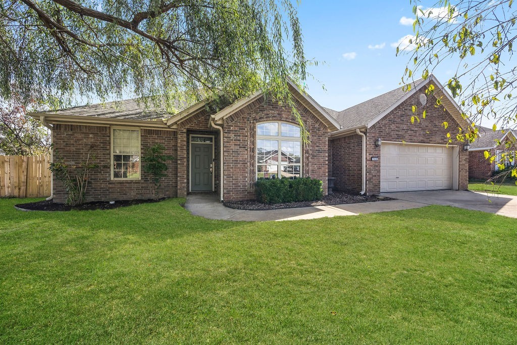 Sensational home in the Prairie Meadows Subdivision! Open concept living space boasts vaulted ceilings and gas-log fireplace flowing seamlessly into delightful eat-in kitchen equipped with custom cabinetry, center island, tiled backsplash and charming dining area. Beautifully updated with fresh neutral color paint, new carpet and new roof being installed too. Practicality with separate laundry room. Wonderful functionality with split bedroom floorplan and spacious bedrooms for the whole family. Unwind from the day and watch the kids play, with fully fenced backyard and covered patio. Prime location that is in the heart of charming Prairie Grove and close to schools, shopping and dining. Withing walking distance to Prairie Grove Aquatic Park and Delford Reiff Park offering pool, ballfields and skate park. Move-in ready and waiting for you!