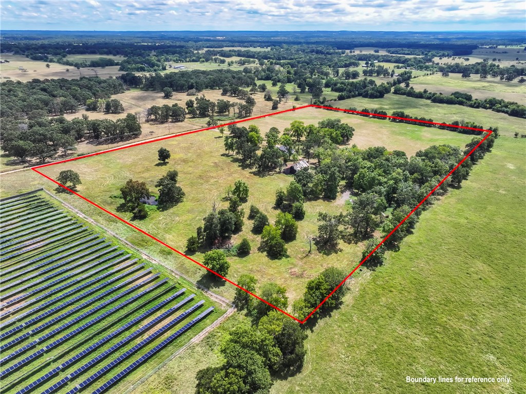Discover 25.97 acres of beautiful country living! This fully fenced property with rural water features level, mostly open land—perfect for livestock—with a serene pond and plenty of space to grow. The property also offers an RV hook up. An old barn adds rustic charm and storage potential, while a 2,025 sq. ft. shop offers versatile living with a one-bedroom, one-bath setup currently used as an open-concept space with kitchen and living area. The shop can easily remain a comfortable home or a workshop with living quarters. With gorgeous views, peace, and privacy, this property is ideal for building your dream home, running livestock, or simply enjoying wide-open country living. **most of the furniture can convey with the property.**
