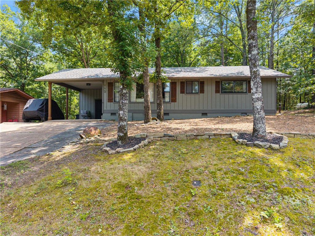This beautifully updated 2 bed, 2 bath home is tucked away in the heart of Fairfield Bay and just a short walk to the ever popular cliffs at Snakehead Cove on stunning Greers Ferry Lake. Inside, you'll find an open concept layout with vaulted, shiplap ceilings, two spacious living areas, and a cozy, welcoming feel throughout. The flexible second living area offers extra space for guests. The kitchen flows seamlessly into the main living and dining areas- perfect for gatherings. Step outside to a spacious deck, partially covered for dining outdoors. The fire pit is the ideal spot to unwind after a day on the lake. This home has been thoughtfully remodeled inside and out, including fresh exterior paint, new gutters and shutters, an amazing deck and a revitalized shed. A laundry room and pantry adds convenience. All appliances, including the washer, dryer & frig will convey! If you're looking for a full time residence or a weekend getaway, this lake area gem has it all. Location, style and comfort!