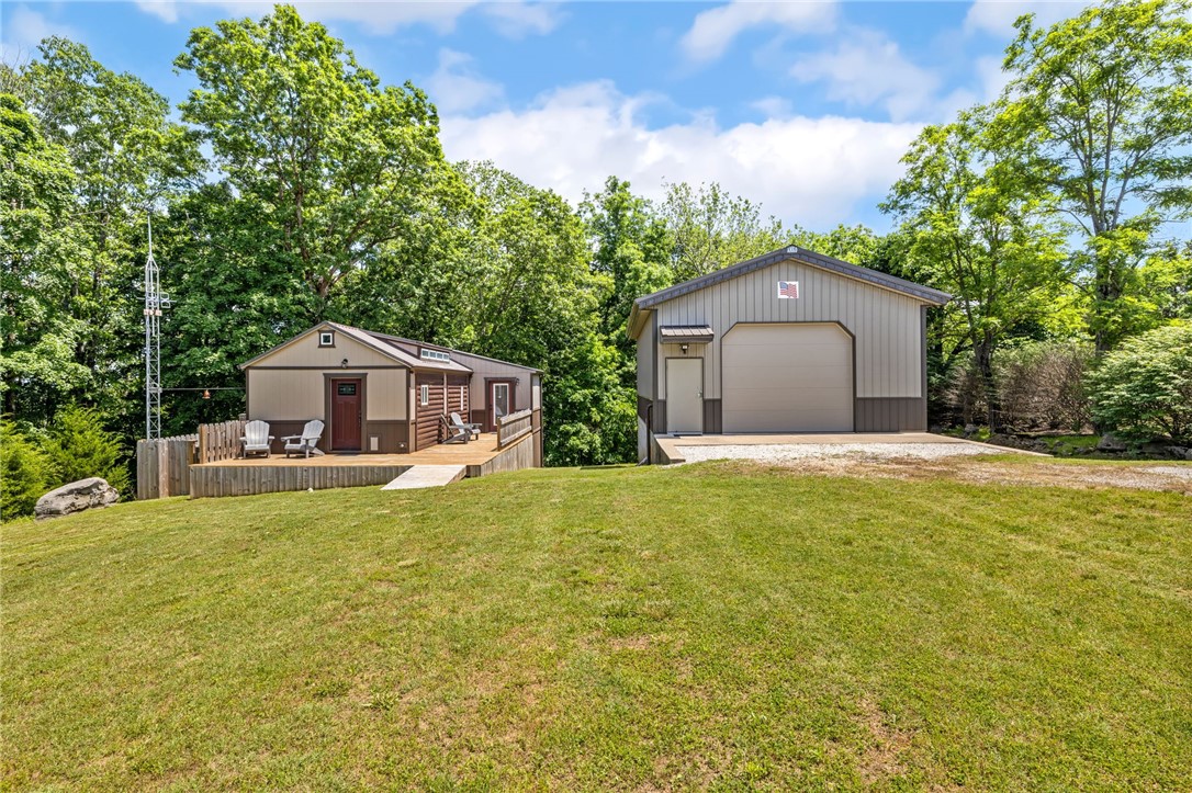 Discover a truly unique offering minutes from Beaver Lake! This custom-built 1-bed, 1-bath home feels surprisingly spacious with its open-concept layout and efficient Daiken mini-split system ensuring year-round comfort and low utilities. But the real magic lies beyond!
Nestled on over 4 private, unrestricted acres, this property boasts an impressive 24x36 heated, air-conditioned, and wired shop with a 10ft door – ideal for any project or passion. Plus, an RV cover with a 30-amp hookup is ready for your adventures. Best of all, it borders 120 acres of Arkansas Game & Fish land, providing unparalleled privacy and access to nature. This is an exceptional, one-of-a-kind property you absolutely must see!