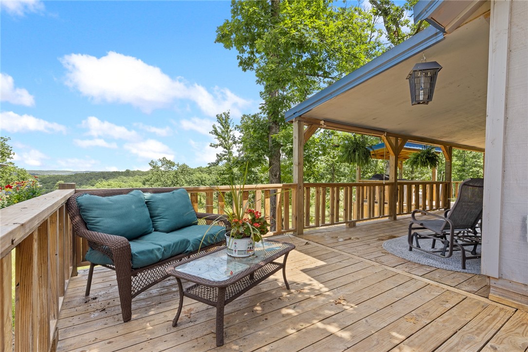 A true gem in the Ozarks! 6.15± acres w/breathtaking sunrise views, this charming 840 sqft cabin, built in 2022, is ideally located just 3.5 miles down easy back roads from the Buffalo River & the historic town of Gilbert, AR. The cabin features vaulted ceilings, spacious primary bedroom, cozy bunk room & a loft-style bedroomācomfortably sleeping up to 6 guests. The full bath includes a large jetted soaking tub w/a shower combo for spa-like relaxation. Enjoy outdoor living on the expansive wraparound deck, perfect for entertaining or soaking in the peaceful surroundings. In addition, the property includes a two-car covered parking area attached to what could easily be finished into a studio apartment. Itās already prepped for a kitchenette and bathroomājust waiting for your finishing touches. Whether you're looking for a private retreat or an investment opportunity, this property offers incredible potential. With room to add additional cabins, stunning views, & undeniable charm, this is a five-star opportunity