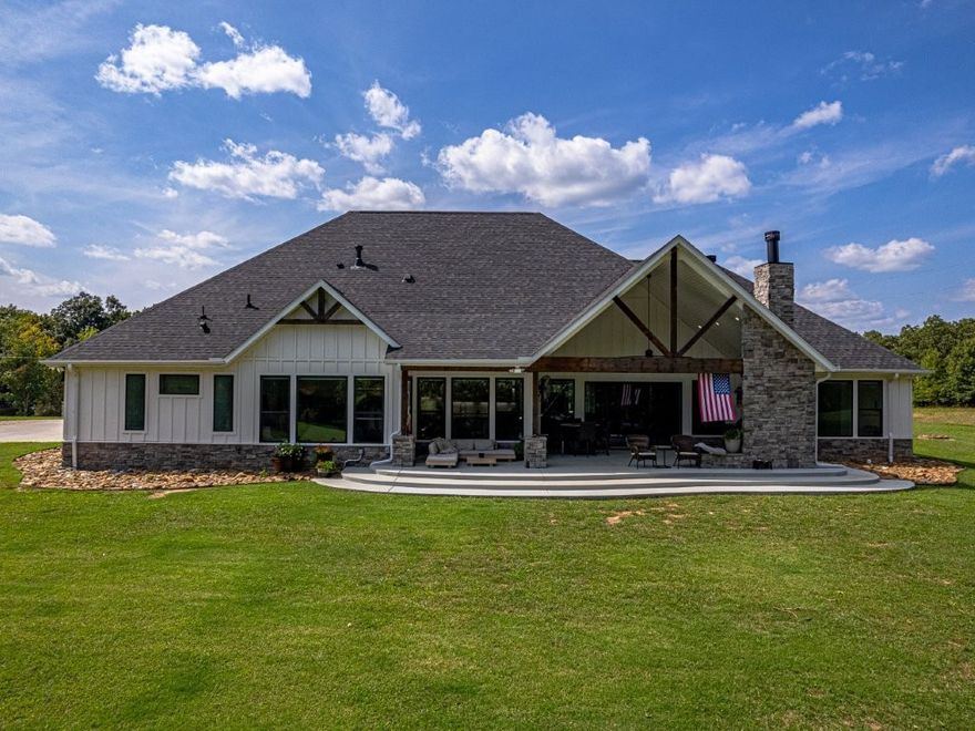 Step into the charm of this delightful 3,600 SF home with 4 cozy bedrooms nestled on 12 picturesque acres. This gem includes a spacious 3,796 SF shop with a 1,400 SF lean-to for equipment and a 1,652 SF complete Apartment, used as a a part-time Airbnb retreat with good reviews. Embrace the farm-like allure, just a stone’s throw from town, enhanced by paid-off solar panels system generating enough power to cover the house and shop. Enjoy thoughtful touches like central vacuum, spray foam insulation, radiant board heating, a covered porch, open/covered patios, a sprinkler system, security features, indoor/outdoor wood fireplaces, and a safe storm shelter. Delight in a powered greenhouse, thriving garden, serene pond, and an outbuilding with a powered chicken coop. Inside, find granite countertops, an oversized kitchen island, clever built-ins, and blackout shades throughout. A true haven of luxury.