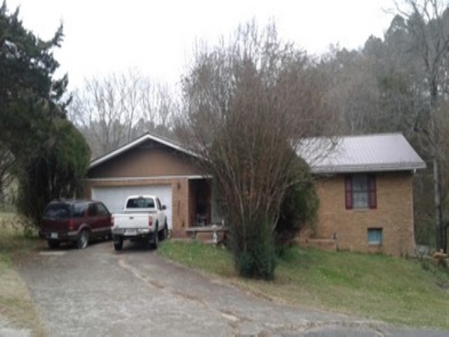 Opportunity awaits in beautiful Jasper, AR! This brick home features 1,683 sq ft on the main level and an additional 1,353 sq ft of unfinished basement space with poured concrete walls—a strong foundation for a major renovation. The property sits on 0.91 acres and includes a two-car garage and metal roof. Please note, the home is in poor condition and will require a complete remodel. Whether you're looking to restore it for personal use or investment, this property offers great potential in a scenic location. Sold as-is. Some of the personal property will be taken out to auction, but the majority of what is there, will still be there on closing day. Photo is from previous tax record photo. Property is grown up now.