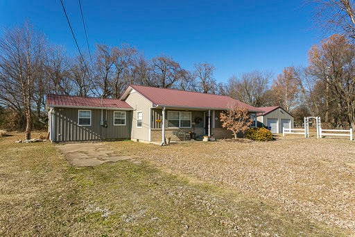 3 Bed 2 1/2 Bath on large lot with a 20 x 30 detached garage/shop. New a/c, dishwasher & carpet in 2016, tile in kitchen & full bath in 2013, gas tankless hot water heater in 2009, metal roof & siding with double insulation in 2008, cabinets in bathrooms & kitchen in 2005. Has two master suites, one with a full bath & one with a half bath, built-ins, covered front porch, deck & fenced backyard. Must see to appreciate.