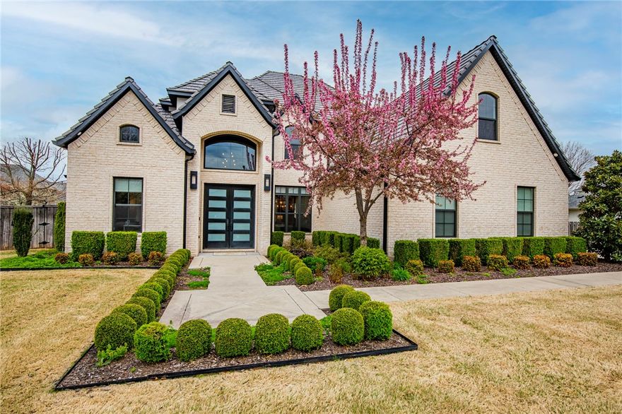 Located in Pinnacle Country Club, this pristine, clean line, contemporary 5-bedroom home offers amazing amenities throughout its designer interior! Sought out floorplan with spacious open living concept featuring large great room with coffered ceiling, fireplace & custom-built ins open to Dining Room and Kitchen.  Chefs eat-in kitchen with quartz counter tops, large island, stainless steel appliances including double ovens and gas range & amazing hidden walk-in pantry all open to the eat-in space that enjoys access to a large, covered outdoor living space. Enjoy the owner’s suite with spa like bathroom & closet, plus a second guest suite/office on the main level. Second level hosts 3 bedrooms all with en-suite bathrooms & a large bonus/game room space with kitchenette featuring a mini refrigerator & microwave. Relax and entertain outside in the fully fenced, private backyard. Other features include a tornado shelter in garage and located in Bentonville Schools.