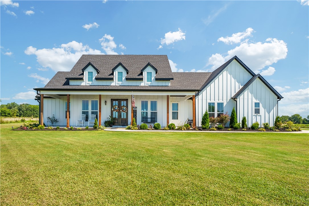 Welcome to this modern farmhouse perfectly positioned on 3 beautiful, flat acres! Impeccably maintained, this home was thoughtfully and intentionally designed for gathering. It offers predominantly main-level living with 3 bedrooms and 2 baths, and a spacious bonus/game room and full bath upstairs that could he a 4th bedroom. An entertainers dream, the fully equipped gourmet kitchen offers practicality and style with a nice island bar and spacious dining area, a charming coffee bar and an oversized "hidden" pantry. The kitchen opens to the living room featuring a grand vaulted ceiling and built-ins flanking the TV/entertainment space. The living room extends to a fabulous screened in patio-a perfect setting for dining or kicking back to watch a game. Luxury with everyday comfort. The primary bedroom boasts a spacious walk-in closet connected to the laundry room, a spa-like en suite bath with freestanding tub and custom shower. Secluded, beautifully landscaped, 3-car garage. A few miles to XNA. A must see!