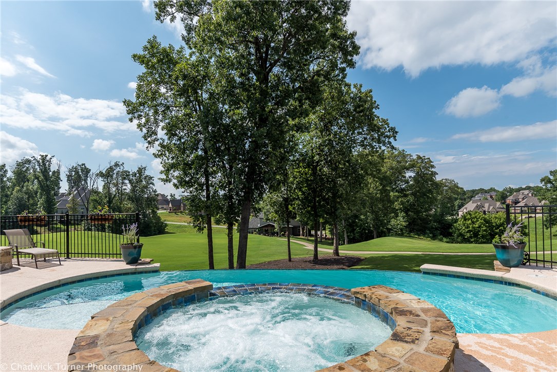 Wanting a home that has it all. Look no further. Resort lifestyle at its best. This stunning golf front home with a infinity pool overlooking the beautiful golf course in every direction is a show stopper. This stunning home has 3 levels of living space with 2 living areas on main level and media room upstairs with game room complete with kitchen area down. The master suite is on the main level overlooks the golf course, and has a spa-like master bath.Quartz counter tops in the kitchen with a expansive main island.The perfect entertaining home. This is a home you don't want to miss,and will not want to leave.