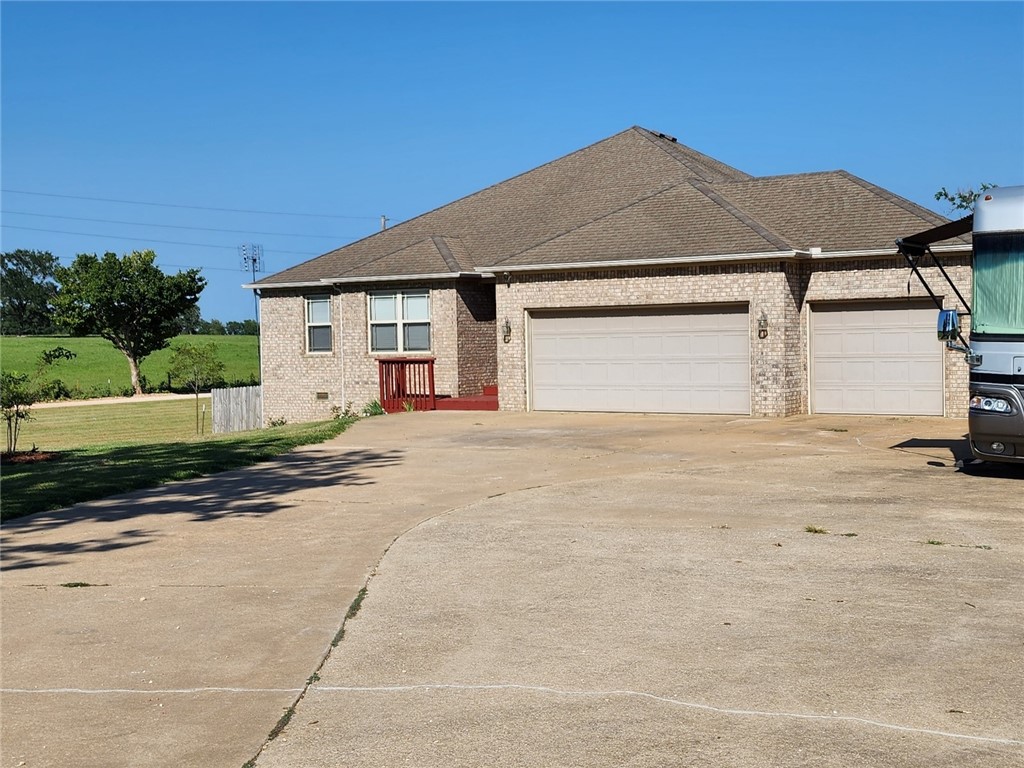 Discover this lovely custom 3 or 4 bedroom, 3 bath, brick home on a serene 2-acre corner lot with stunning countryside views. Bentonville mail, Pea Ridge City limits, schools. Features 2556 sq ft, 3 car garage, multifunction lower-level room w/full bath, exterior door onto back yard. Prewired for an 8-person hot tub, full RV connection w/extra pad. The 10x12 heated/cooled She Shed & a 16x24 workshop provide ample space for hobbies or relaxation. House comes equipped w/state-of-the-art tech., including Cat5 & RG51 cables, two 5.1 surround sound systems powered by Control4., more! Address is on a bike race trail/road.