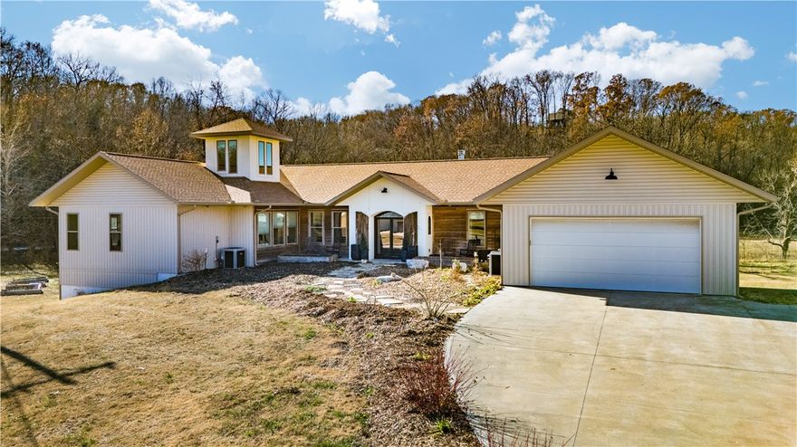 This one of a kind custom home has it all: 5 bedrooms, 5.5 bathrooms, office, 4,448 sq/ft of living space with an additional 3,740 of unfinished basement area, garage space for 6+ vehicles, workshop space, 3000 sq/ft shop on 10 acres and just minutes from I-49, Lake Bella Vista and Blowing Springs Park. Featuring an open floor plan with a large living space, gourmet kitchen, massive amounts of cabinet and storage space, this home is perfect for a large family, entertaining or just simply spreading out. The large, luxurious primary suite offers everything you could ask for: massive walk in closet, soaking tub, abundant shower and tons of storage and counter space. The unfinished basement area offers endless opportunities to expand. Solar power keeps utilities to around $200/month for the entire property. This is truly a must see property to appreciate.