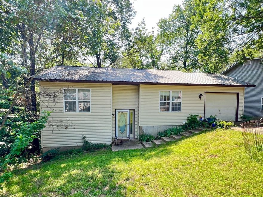 Discover the perfect blend of comfort and charm at 107 Jay Lane, a delightful property situated in the scenic hills of Eureka Springs. This inviting home is an ideal space for those seeking the convenience of being located right in town yet not wanting to sacrifice being surrounded by the natural beauty of the Ozarks. This charming house is not just a home, it is sanctuary that offers  a perfect escape while being close to all of the vibrant community interactions of Eureka Springs. Five star dining, exciting night life, and exquisite art shopping are all just minutes from your front door. There is tons of potential with the unfinished lower level. There is certainly room for your own input and design spin. There is potential to add two additional bedrooms in the lower level. You could also permanently separate the two levels into apartments and turn this great investment property into a duplex. Whether you're looking for a permanent residence, an investment or a vacation getaway this property is a must see.