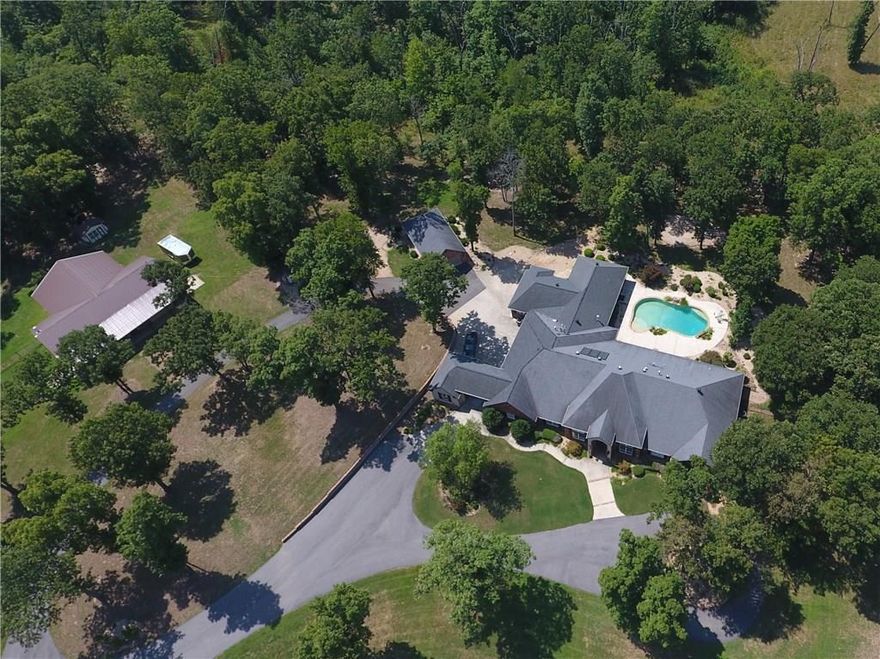 Private 24 acre Bentonville Estate located on stunning hilltop setting minutes from Downtown! Long winding private driveway leads to the 6800 sfeet estate home on one level, 7 BRs, 5.5 Baths. A True gourmet chef's kitchen like no other! Featuring Double Islands, SubZero Refrigerator, Wolf Commercial Grade Appliances. Saltwater pool, Media Room, Exercise Room, Study. Detached 4 car garage and 60 x 60 horse barn with workshops. Full spec sheet of whole house amenities and upgrades available upon request. Shown by Appointment Only. See Matterport Link for Virtual Walk through Tour!