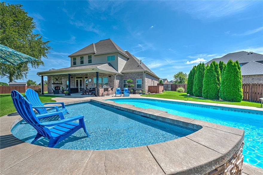 Fabulous custom-built Landmark home, perfectly nestled on a .38-acre lot at the end of a quiet cul-de-sac. Enjoy your own backyard paradise with a stunning outdoor oasis and breathtaking sunsets! A newly added saltwater pool with a tanning ledge and soothing waterfalls, paired with a spacious covered patio featuring an outdoor kitchen and cozy fireplace, creates a truly serene retreat! The gorgeous interior offers beautiful custom touches throughout with 4 bedrooms, 3 full/2 half baths, private office, main level guest suite, formal dining, living room w/ fireplace and a stunning chef’s kitchen featuring a large island, gas cooktop, double ovens, built-in professional grade fridge/freezer & pantry!  Luxurious master retreat w/ en suite bath & walk-in closet! Second level hosts 2 bedrooms, 2 baths, a bonus room and media room! 3 car garage w/ storage & storm shelter! Within walking distance to Fairview Elementary and just minutes to shopping, restaurants, and Walmart AMP w/ direct access to Razorback Greenway!