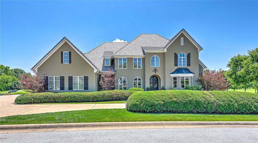 An extraordinary 3-level home combining family comfort & opulence in NWA’s most prestigious address. This 7,319 sq ft home is on a 0.55 acre lot with gorgeous views of hole 14 on NWA’s Premier Championship Golf Course. With 5 bedrooms, 6 full baths, plus 2 half baths, this house welcomes both family and guests with ultimate luxury. This home boasts custom high-end finishes throughout. Spacious open concept living area, high ceilings, wrought-iron balcony, chef’s kitchen with professional appliances, formal dining space, plus a large island with bar seating. A master suite has large windows and a fireplace. The master bath creates a spa experience with a glass shower & dual built-in for endless storage. Entertain guests with numerous outdoor spaces. The ground floor includes a large veranda & outdoor kitchen plus dining space adjacent to a gorgeous pool with large patio space surrounded by lush grounds. The vast 2nd floor entertaining space features one of the best views of the course, perfect for the Club events.