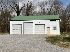 Major road frontage. High traffic count. This property sits about a mile from the XNA Airport entrance. The property sits on approximately 1.90 acres with a 3 bed (or office) one full bath house (1,612 sq ft +/-) and a three, overhead door shop (2,000 sq ft +/-). Previous tenants had a cabinet making business in the shop and used the house as an office. Would be great for a construction business, landscaping business or auto shop. Any commercial use will need to be verified with the City of Highfill.