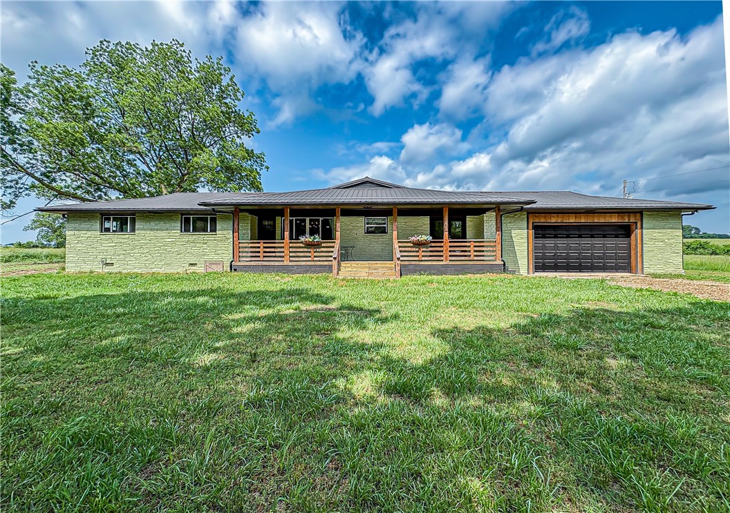 This beautifully renovated rural property offers the perfect blend of timeless charm and contemporary comfort. Nestled on a spacious, flat, and fully cleared lot, this stunning 4-bedroom, 3-bathroom home has been thoughtfully updated delivering the ideal setting for peaceful living without compromising on modern conveniences. Step inside to discover nearly new everything from the foundation to roof! Features include high-end finishes,new flooring,and stylish lighting throughout. The heart of the home is the updated kitchen, complete with sleek countertops, new tile backsplash stainless steel appliances, and a large center island. The luxurious primary suite is a true retreat, featuring a generously sized bedroom, walk-in closet, and a en-suite bath with a soaking tub, double vanity, and a walk-in tiled shower. Outside, enjoy the beauty and tranquility of rural living with plenty of room for a garden, hobby farm, or outdoor recreation—all on a flat, usable parcel of land with endless possibilities. Endless updates!