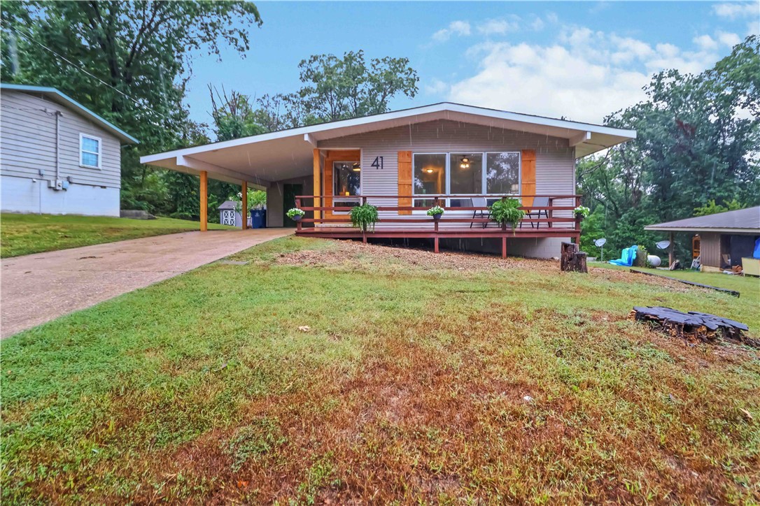 This beautifully updated 2 bed, 1.5 bath home with an attached carport and storage closet is move-in ready and full of charm. With its modern upgrades and flexible layout, it’s perfect as a primary home, weekend getaway, or even a short-term rental/Airbnb investment. Features & Upgrades: Two spacious decks (front & back) for relaxing or entertaining, Brand new LVP flooring & fresh paint throughout, New doors, hardware, light fixtures & ceiling fans, Upgraded kitchen: custom cabinets, granite countertops, stainless steel appliances & added dishwasher, Bathrooms refreshed: added half bath, enlarged full bath, new bathtub, surround & toilet, All new plumbing (including pipes), Enhanced curb appeal with shutters and exterior updates. This cottage blends modern convenience with cozy charm—completely refreshed and ready for its next owner, just minutes from the Little Sugar bike trail and the new Mountain Bike Park being built!