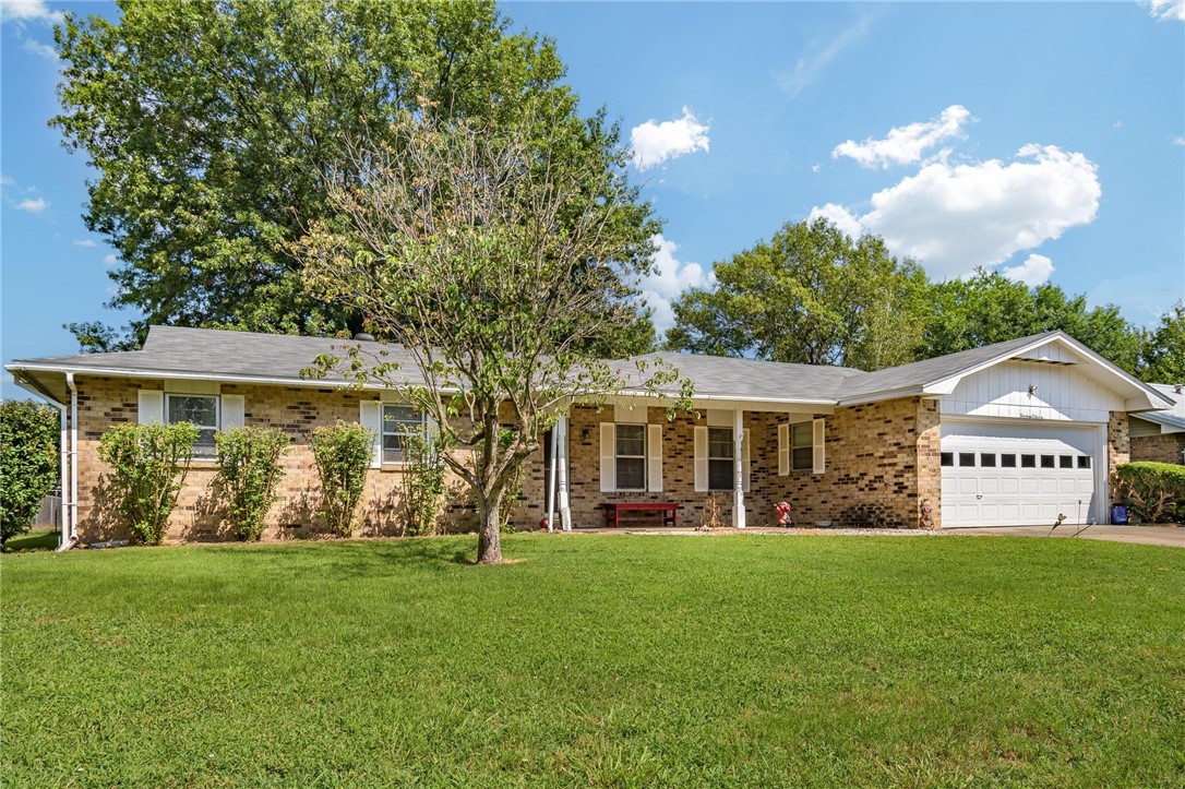New roof this week! This classic Springdale home is ready for its next chapter! You'll find it tucked away in a well-established neighborhood, just minutes from everything. Centrally located, the home itself has plenty of living space, a spacious eat-in kitchen, and a sunny enclosed sunroom. The backyard is an ideal spot to relax, with a mature tree providing plenty of shade. The location truly can't be beat. You're just a 10-minute drive to both downtown Springdale and the Tyson home office, and less than 5 minutes from I-49. JB Hunt is about 15 minutes away. As an added bonus, the roof has a 25 year transferable warranty.