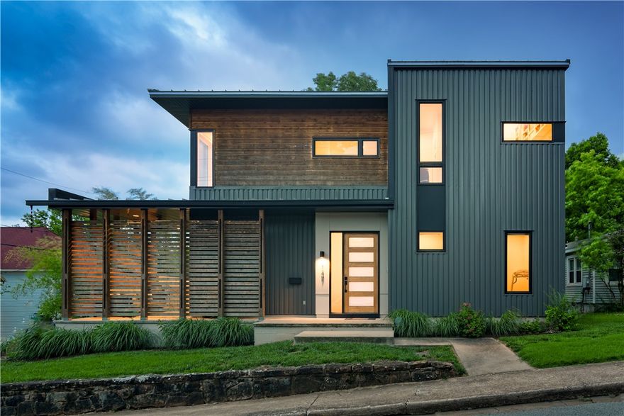 Welcome to this luxurious Fayetteville home, ideally situated near Downtown Fayetteville, Dickson Street, and the University of Arkansas. The modern design and open feel of this 3 bedroom, 3 bathroom home is complete with soaring ceilings and offers the epitome of contemporary living. The eat-in kitchen boasts quartz countertops, a double oven, a large walk-in pantry and more. Step outside to the covered patio to relax and entertain guests while enjoying the pool and hot tub. Upstairs, a customized library nook area, movie room space, and a kitchenette offers a cozy retreat for reading or watching your favorite films. After a long day, unwind on the upstairs balcony that provides picturesque views of the area. The oversized garage is a car enthusiast's dream, equipped with a central drain, coated floors, tall ceilings, a sink, and ceiling fans. Experience luxury living in this stunning Fayetteville home, where modern design meets convenience and comfort!