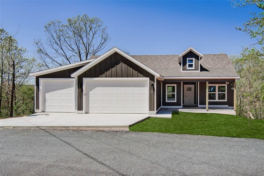 Stunning new construction home in Bella Vista, perfectly situated near Lake Loch Lomond, Branchwood Recreation Center, Highlands Golf Course, and the Tiree Park boat launch. This thoughtfully designed home features a spacious 3-car garage with an open split floor plan and beautiful wooded views! Inside, you’ll find 3 bedrooms, 2 bathrooms, and a versatile office or flex space. High-end finishes throughout including 3cm quartz countertops, Pella windows, a custom accent wall, and a large covered front porch. The 16x16 partially covered back deck featuring a wood ceiling is perfect for relaxing or entertaining! Additional upgrades include Presidential-line architectural shingles, an oversized walk-in tile shower in the primary suite, and a spacious laundry room with a custom built-in mudroom area. With quick access to the bypass, commuting around NWA is simple and stress-free!
