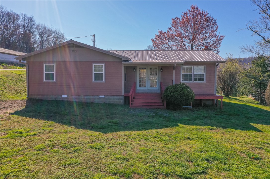 Check out this adorable home in the country. Home has a welcoming wood fireplace in the great room, separate dining area, and two covered porches to sit on while enjoying your coffee and listening to the sounds of nature. New heat and air system in the home as well as updated kitchen. There are two spacious storage buildings, a detached carport, cellar, and two older homes being used for storage. The property borders a creek with a great space for a garden. This home is located within minutes of the White River and Mill Creek OHV trails. Located 30 minutes from Fayetteville, this property provides you a respite from city life.