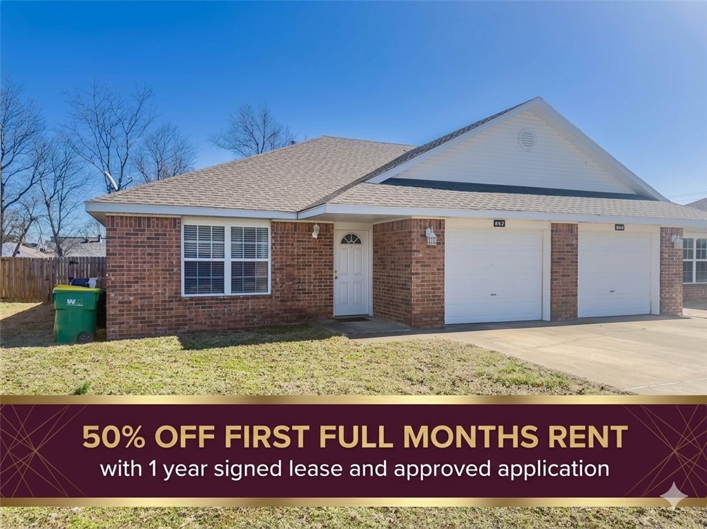 Single story home with brick siding, driveway, an