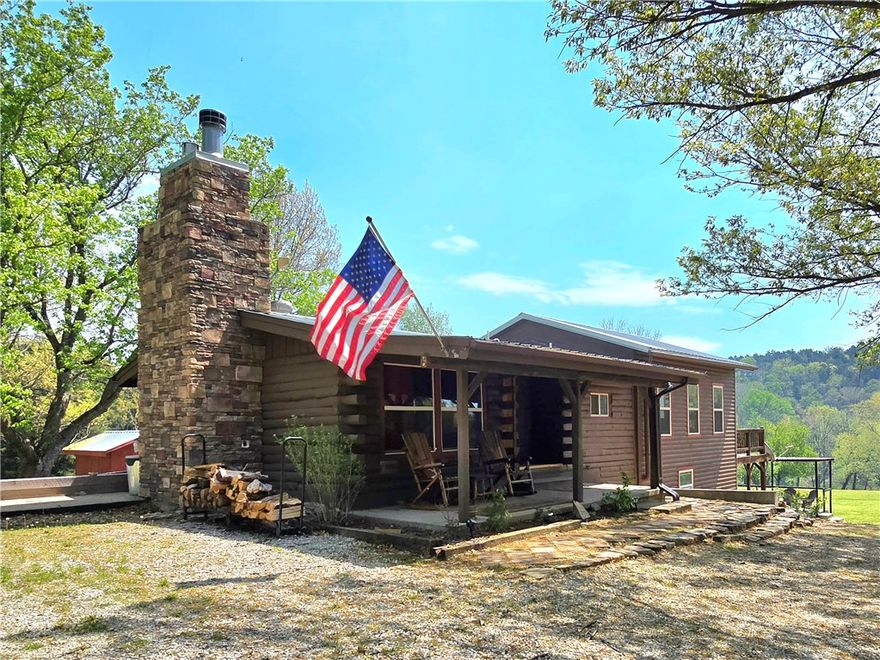 Welcome home to your own oasis on the Kings River! This rustic and charming home sits on 5 pristine and park like acres that lead gently down to an easy and private access to the Kings River. Relax and unwind as you sit around the firepit on the natural stone patio or by the river's edge, or while you play a round of frisbee golf or horseshoes! This could be an amazing primary, vacation, or income producing property. Inside the home you will find 3 bedrooms, 2 baths, 2 large living spaces, a wood burning fireplace in the main living room, wood accents throughout, a charming kitchen with granite countertops, stone backsplash to the ceiling, and stainless appliances, a laundry room on each level, a primary bedroom with a gas log fireplace, screened in porch, and so much more! Detached garage/shop. Private well. Drivable access to the river. This is a one of kind property and it is a must see!