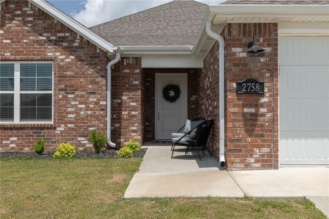 PRICED BELOW COMPS TO SELL!! This charming 4 bed/2 bath all brick home is in pristine condition and ready for its next family. Located near the Razorback Greenway, Lake Fayetteville Trail, Botanical Garden and Willie George Park (splash pad, ball fields) with easy access to Highway 265, Highway 71b and I-49, the setting is premier for the on the go family, empty nester, active professional, or an ideal rental property. Built in 2022, the house has been very lightly lived in and features all the modern amenities one would expect. Stainless appliances, including gas range, large island, coffee station and granite in the kitchen. Gas fireplace adorns the spacious living room. Nice sized bedrooms which are carpeted. All other floors are finished in luxury vinyl lank (LVP). Primary suite has dual a vanity, soaker tub and tile corner shower. The large back yard is fully fenced with wood privacy pickets and features a covered back patio to enjoy the spring rains in comfort.