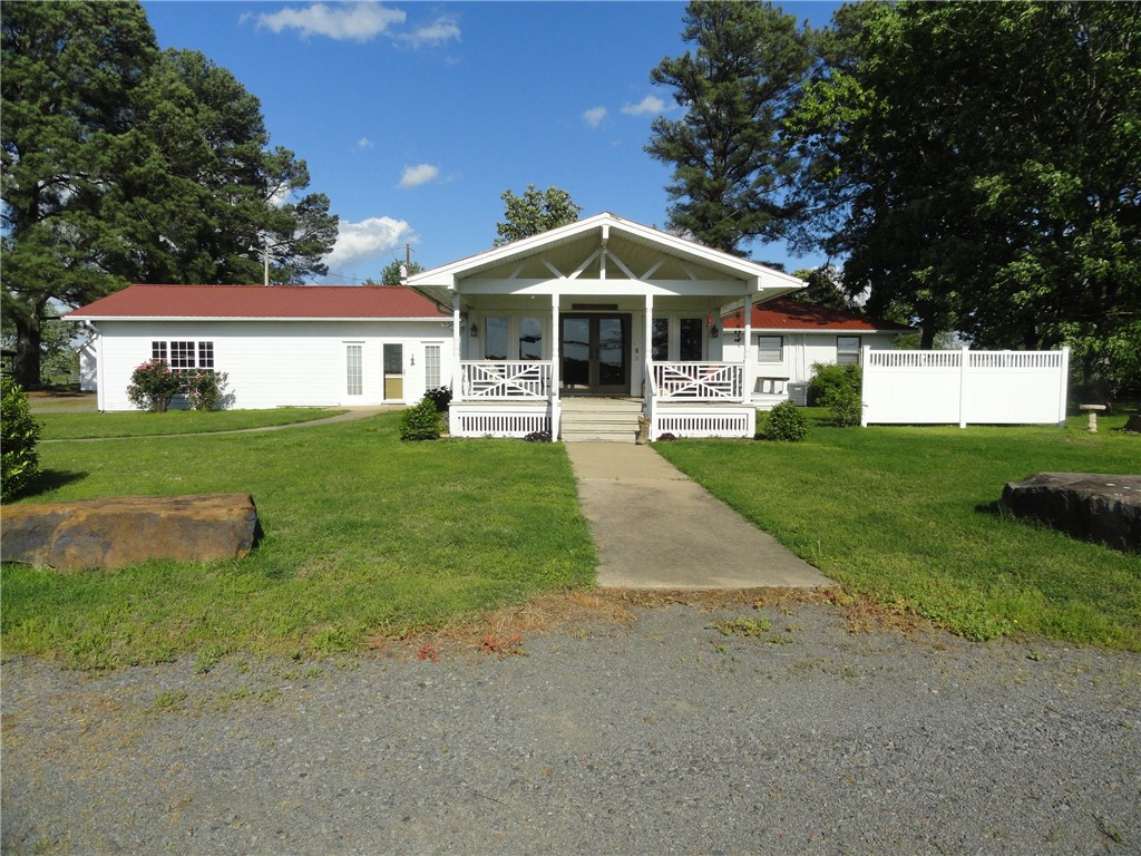 Country charm meets convenience! This beautiful 3 bed, 2 bath home offers 2,115 sq ft of living space, unique kitchen architecture, custom made wooden design & accents in the main bath & custom made wooden storage cupboard, oversized walk-in closet with makeup vanity for the wife, laundry room, formal living room and formal dining area as well as a dining area with the den which has a natural gas fireplace and extra sitting area looking out at a covered back porch, perfect for relaxing. The property which has 45.94 acres of fenced/cross-fenced, cattle-ready pasture, 3 ponds and cattle working equipment make this property ideal for livestock or hay. Features include a 2-car attached garage, metal roofs on all buildings, 5-slot dog kennel with outdoor dog runs, 48’x18’ future horse stall space, 24’x44’ storage area, 24’x52’ barn, 28’x18’ shop, garden spot, and a charming “She Shed.” Enjoy peaceful country living just 0.5 miles from grocery, gas, pharmacy, restaurant, 2 banks, and a cattle auction.