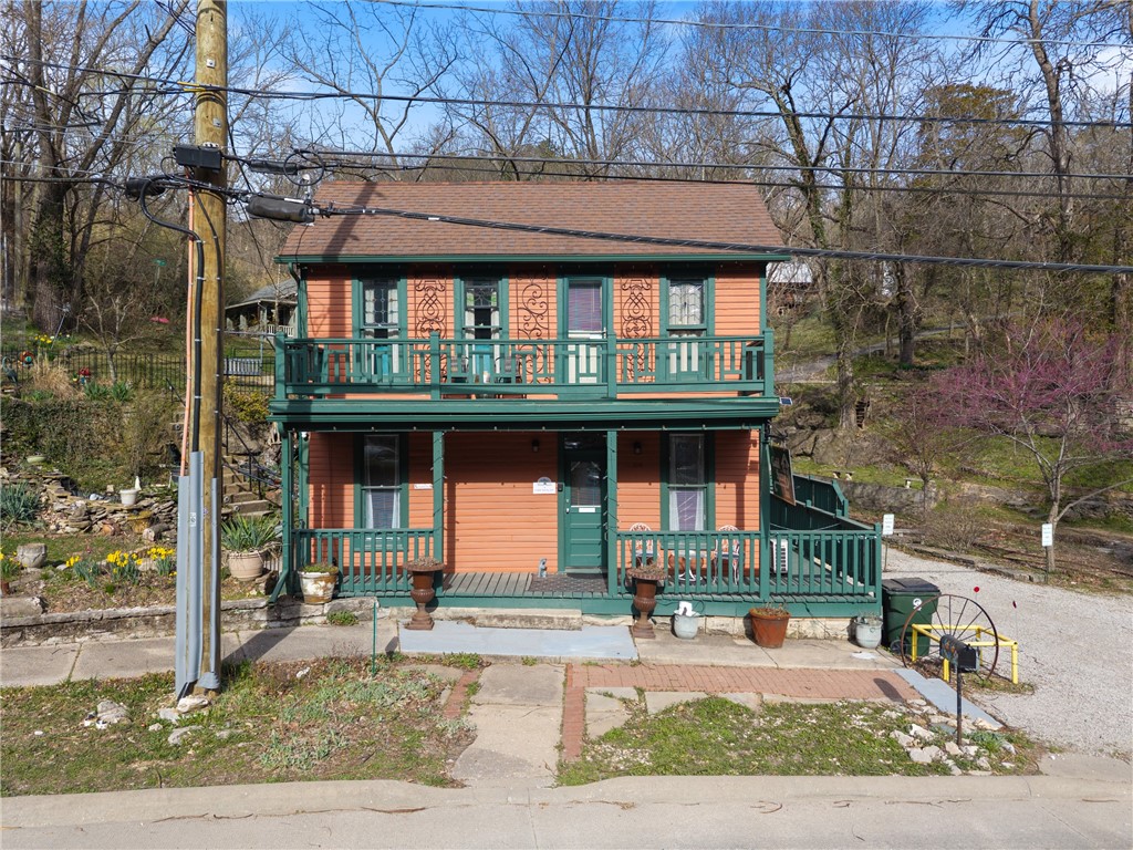Gadd Spring Inn is a step back in time and embraces the beauty of the meticulously restored 1880's Gadd House. This enchanting property boasts a live spring with grotto creating a serene and unique feature that enhances the beauty of the home. There are three distinctive suites, each designed with its own character. Gorgeous restored flooring, copper ceiling tiles, and exposed original walls showcase the craftsmanship of the era while blending seamlessly with modern comforts. Walk-in showers in each suite offer contemporary amenities and the stained glass windows add an artistic touch. The spacious kitchen with butcher block countertops is ideal for preparing meals for family or guests. Multiple outdoor areas and alcoves surround the home, offering quiet spaces to unwind or entertain while enjoying the scenic surroundings. Era-appropriate furnishings provide a cozy, vintage feel, and most of the furniture, along with all linens, convey with the property, making it a fully turn-key inn, shop or private home.