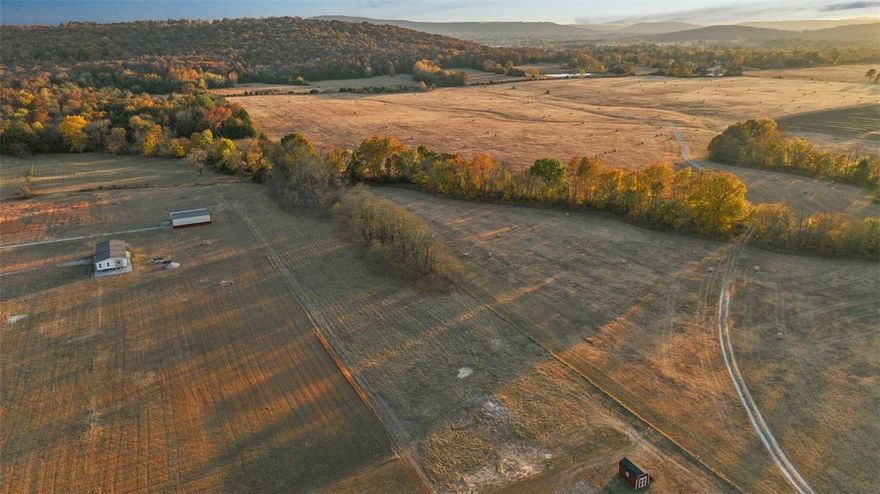 Three acres of flat and peaceful land ready to build the home of your dreams! Just six miles to Fayetteville & easy access to U of A, but away from the hustle and bustle of town. With open spaces on two sides of the property, the views of the White River Valley abound. Close to Lake Sequoyah. Less than one mile to White River access. No covenants here leaving you open to make this space your own. Water and electricity at the street (buyer to verify utility availability to their satisfaction). Perc test completed and capable of handling up to a 4-bedroom home. See attached survey and perc test.