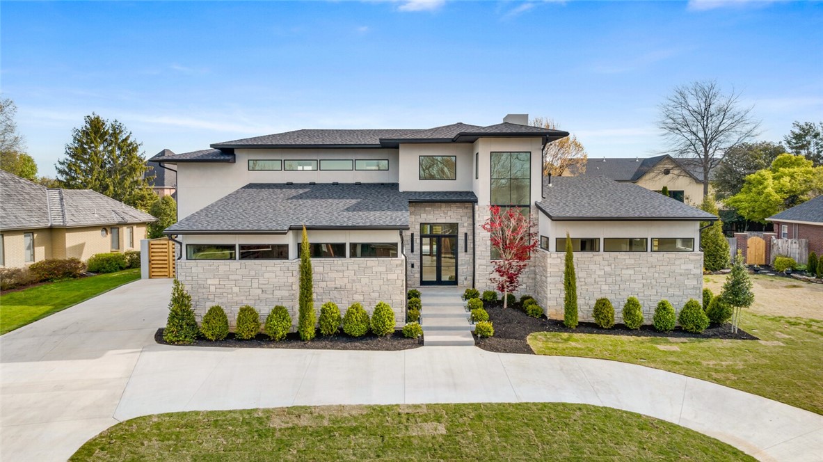 Luxurious new construction home, where unparalleled craftsmanship meets flawless design. This stunning 5-bed, 5.5-bath residence boasts a spacious 5,381 sf of sophisticated living spaces, designed to cater to the most discerning tastes. Step inside to discover the breathtaking open layout, impeccable wood flooring & walls of glass that provide an infusion of natural light & inviting ambiance. The chef's kitchen is equipped with top-of-the-line appliances, waterfall edge island, custom cabinets & adjacent butler's pantry that maximize both style & functionality. This home is filled with thoughtful amenities that elevate everyday living: sunroom for year-round enjoyment, spacious bonus room, 2nd kitchen thatās perfect for hosting, home generator & storm shelter. The expansive patio area with grilling station offers ample space for al fresco dining and lounging. Enveloped by the residence, the saltwater pool with water feature becomes an integral part of the architectural canvas providing an aura of peace and privacy.