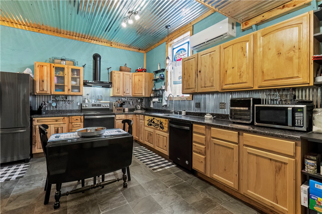 Discover the perfect blend of comfort & functionality with this unique barndominium-style residence on 2.66 level, landscaped acres in the highly sought-after Bergman School District. Surrounded by a variety of trees, flowers, & open green space, this property offers peaceful country living with modern conveniences.
The inviting covered front porch is ideal for morning coffee, while the open rear patio with a firepit sets the stage for cozy evenings under the stars. In case of a power outage, a diesel-fueled generator keeps things running smoothly.
Inside, you’ll find 1,000 sqft of living space featuring 2 bedrooms & 1 bath. The kitchen boasts beautiful hickory cabinets, plenty of storage space throughout, & each bedroom features a custom barn door for the closets, adding to the home’s rustic charm.
The highlight? A 3,300+ sqft shop that’s fully insulated & ready for any project, hobby, or storage need—perfect for car enthusiasts, small business owners, or anyone in need of serious workspace.