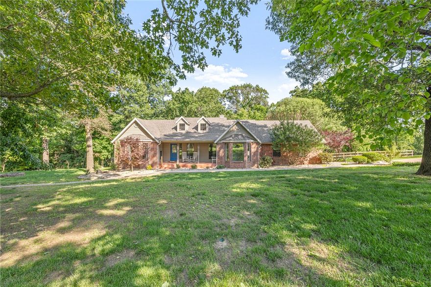 Home & 7 Acres located right off NW 3rd St! Nestled in wooded setting on private drive, featuring 4 Bedroom Home along with a 2,000 SF 4 bay shop & detached guest house. Next to Schools & Coler Mountain Bike Preserve w/easy access to Bentonville Square and Walmart Campus. Updated with fresh paint, renovated primary bath, new decking and more! Foyer entry with formal dining space on right featuring wood flooring and large windows. Living room has wood flooring & access to deck. Eat in kitchen is bright and spacious w/new appliances, island & great workspace. Two guest beds share guest bath and third guest bed has its own attached bath. Primary bed has wood floors & bay window; attached bath has separate vanities & large walk-in shower. Home office has access to primary suite & living space. Deck is great for outdoor entertaining w/ built in hot tub overlooking your private wooded acreage. No covenants, you can start your homestead, rent the guest house & more! Don’t miss out on this rare find in NWA!