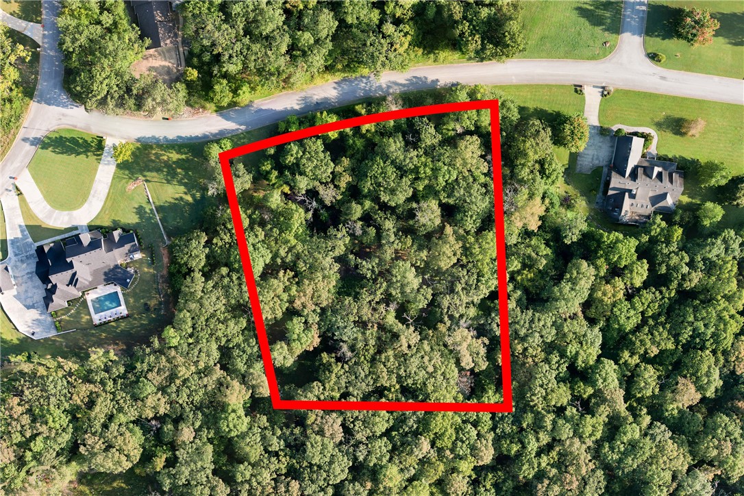 Build your vision on 2.05 acres in a prime Springdale setting. Surrounded by established homes, this property provides a peaceful backdrop with the convenience of nearby amenities, including shopping, dining, and schools. With ample space for outdoor living, a garden, or even hobby areas, this lot gives you the freedom to create a home tailored to your lifestyle. Rarely does a property offer both privacy and easy access to everything Springdale has to offer, making this an exceptional opportunity for your custom build. Heated square footage minimum is 3,000 sq. ft. Please read covenants for additional requirements.
