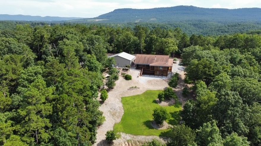 Rare opportunity — 7.32 acres a half-mile from Buffalo National River’s Hasty Landing. Own this beautiful gem of the Ozarks!!  Here it is!! The 2018 home (3,230 sq ft) offers wraparound covered decking, pine-accented living spaces, stone fireplace, custom kitchen, and ensuite with dual closets and a jacuzzi, stone shower accentuate this beautiful space. AMENITIES ABOUND all over this property. Including, but not limited to; a fully equipped studio apartment for guests or staff, a 2,000 sq ft RV/auto garage, two open metal garages, tiered gardens, and fruit trees. Plenty of room to add a cabin or expand guest capacity. Strong rental and B&B potential for outdoor recreation visitors. Make an appointment for your private showing today.