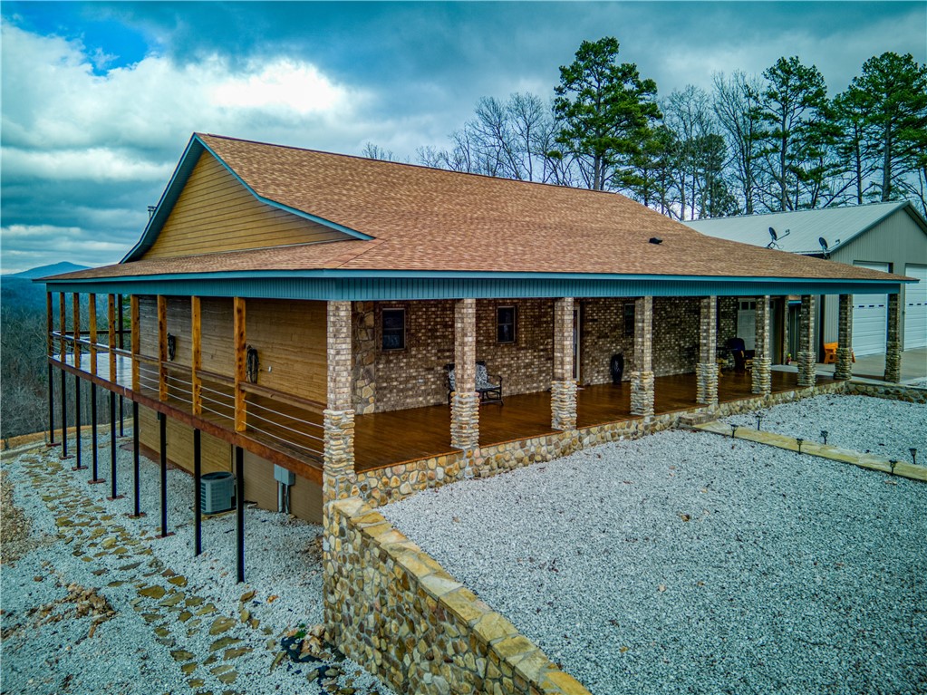This 7.32 acre property is very nicely located and has the infrastructure for a B & B that could pay for the place. Located 1/2 mile from Buffalo National River Hasty landing where you input for floating, it's an ideal location for tourists coming for vacation for fishing, hiking, camping, horseback riding, and Zipline potential. It has 3 buildings with 2000 sq' RV & automobile garage, full utility studio apartment ideal for B & B or rental and 2 open ended metal garages for parking. Custom built in 2018 this 3230 sq' home features a beautiful covered wooden deck that surrounds the brick, stone and custom siding outside walls. Upstairs living room ceilings and walls are pine, with stone fireplace, custom kitchen cabinets, & tons of storage. Master bed and ensuite bath have dual closets, sinks, walk in jacuzzi and shower. Downstairs has living room, bath, two more bedrooms & metal storm shelter. There are Dogwood & fruit trees, tiered gardens and enough land to add a cabin.