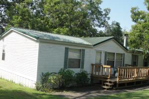 Great Buy! Owner will let 1 and one-half year old refrigerator, range & 8 month old freezer all go with home. Roper washer, dryer & dishwasher all included. New 40 gallon hot water heater, green metal roof, asphalt driveway, metal carport, outbuildings, storm shelter and lots of contents could be included. Clean one-owner home on a corner lot. Owner downsizing and motivated to sell. Move in ready home.