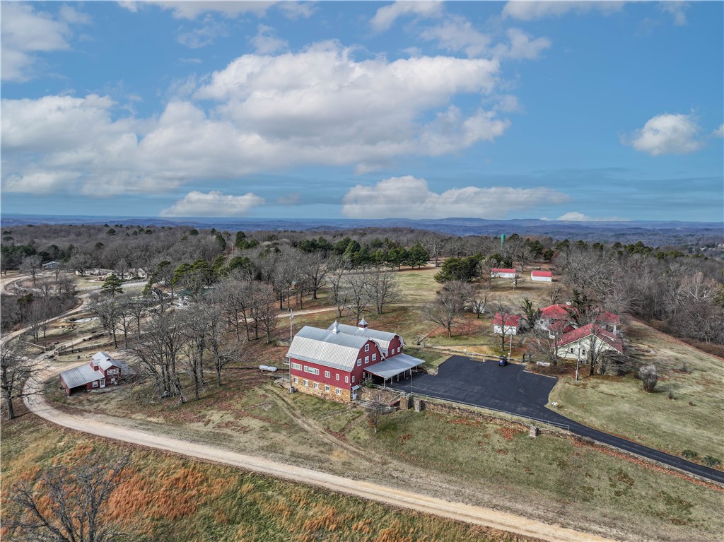 A rare opportunity to own a historic gem in one of the most coveted neighborhoods in Eureka Springs! The property known as Hillspeak spanning over 34 acres is rich in history! The main 10,000 sq ft iconic red barn was a true dairy barn prior to becoming the main printing and processing location of the "Anglican Digest" accompanied with a small beautiful chapel. The time has come to have a new dream brought to life with endless possibilities on this magnificent property featuring 5 living units (former rentals) in addition to the main barn. There are also multiple outbuildings for shop space, storage, etc. A large community well that serves the local neighbors is maintained on site. This property is truly a one of a kind and needs to be toured to fully appreciate the opportunity that exists here. Showings by appointment only to pre-approved buyers. Last chance to keep this iconic property together - survey has been ordered to begin splitting into smaller parcels and listings.