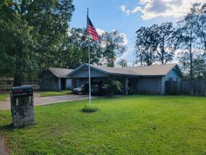 A spacious 3-bedroom, 3-bath home near Petit Jean Mountain features a large family room, walk-in closets, an office, and a 16x32 in-ground pool. It has a 30x36 shop. The yard is fenced with a 6ft privacy fence, offering a great outdoor space for relaxing or entertaining.