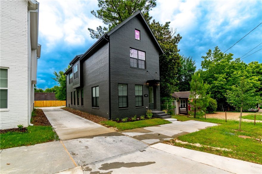 Brand new all-brick luxury only minutes from the Fayetteville Square, Farmers Market, University of Arkansas, a wide variety of dining options, shopping, biking/walking trails, Dickson St, and all the vibrant amenities of Downtown Fayetteville! The home boasts 3 spacious bedrooms, each with its own private bath, and 3.5 baths total. The main living area, kitchen, stairs, and hall feature beautiful engineered hardwood floors, adding elegance throughout. The gourmet kitchen is a chef’s dream, with a large island, luxury 3cm quartz countertops, and a high-end gas range. Custom-built cabinets extend to the ceiling, and gorgeous trim and cased windows add to the overall sophistication. This home includes a 1-year builder’s warranty. Don’t miss your chance to own this beautiful, move-in-ready home in a prime location!