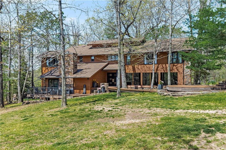A one-of-a-kind opportunity! Newly remodeled, very private, mid-century Fay Jones style home on Roger’s Lake Atalanta - 2 acres. 5 minutes from all downtown Rogers has to offer; two miles to Beaver Lake and private access to trails. POA includes privacy granted by over 30 acres shared by only 3 neighbors – no additional homes allowed unless ALL 3 owners agree. So much is new – kitchen, bathrooms, decking, lighting, paint, carpet, gutters, custom modern metal railing inside and out. Buyers have the option to purchase slip/lift transfer at Horseshoe Bend (Dock #2, Slip #38) with Cobalt boat to enjoy boating on Beaver Lake as well as hiking/biking from the backyard at Lake Atalanta. Creekwood Hill is a Private Drive! Directions (Not GPS) from Rogers E on Hwy 12. R on Dream Valley. R on N Pleasant Ridge Rd. R on Creekwood Hill. Showings begin Wed Seller reviews offers Sun. after 5pm and respond to offers Mon. 7pm. Pre-Approval or Proof of Funds to be submitted with the offer. Public Open House Sat & Sun.