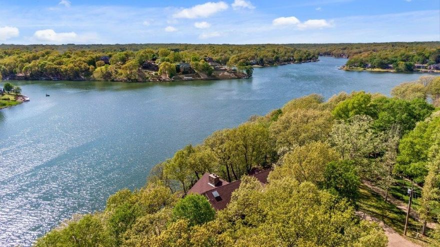 17 Torrido Ln borrows from the famous Frank Lloyd Wright style that blends rather than competes with nature. This estate has some of the most panoramic views and private lake access on the largest of the Bella Vista lakes, Loch Lomond. This 5000 SF foot home in NWA harbors great fishing, water sports, excellent community and fabulous outdoor amenities. With 1.44 acres and 441' of private shoreline with 120' of new sea wall, this property is one of the most private on the lake. There is a boat dock, locked storage, fridge, kayak launch, a swimming dock, sitting dock, and fire pit. Congregate at the local marina which has a filling station, bar and restaurant. Other amenities within 10 minutes or less include local pickleball courts, golf, indoor swimming, gyms, yoga, and the infamous NWA bike trails. See attachment for complete remarks. 3 bedrooms with private baths, study with built in bookshelves, other room perfect for home gym with closet. Much of the furnishings convey with estate. Contact agent for a list.