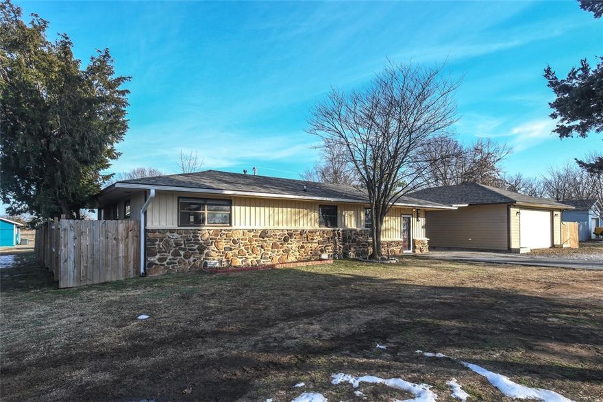 Seller has recent appraisal-348K! Ready for comfortable living &/or multi-generational/rental possibilities! 3 heated & cooled improvements, for various rental income opportunities. It is directly behind a commercial property, making it  a real option to run a business out of garage w/proper zoning & permitting. Beautiful, versatile property featuring a 3-bedroom home w/a dedicated office (or easily used as a 4th bedroom), a warm living room anchored by rock fireplace that is ducted throughout the house for an additional heat source, & an updated kitchen wi/gas range & granite countertops. Exterior highlights include a covered carport/walkway leading to an oversized, heated & cooled garage workshop—perfect for projects or storage—plus a 12' x 24' covered deck ideal for grilling and watching games and a large fenced backyard for privacy and play. Bonus separate 1-bed/1-bath building (currently rented) with kitchenette and living area offers excellent mother-in-law quarters, guest house, or income-producing rental.